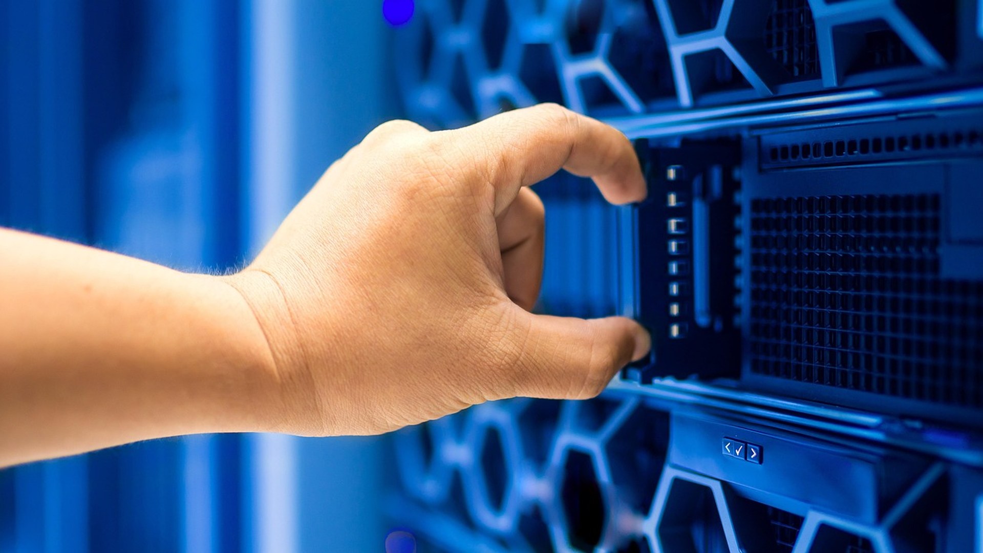 IT technician adjusting server rack equipment for managed IT support