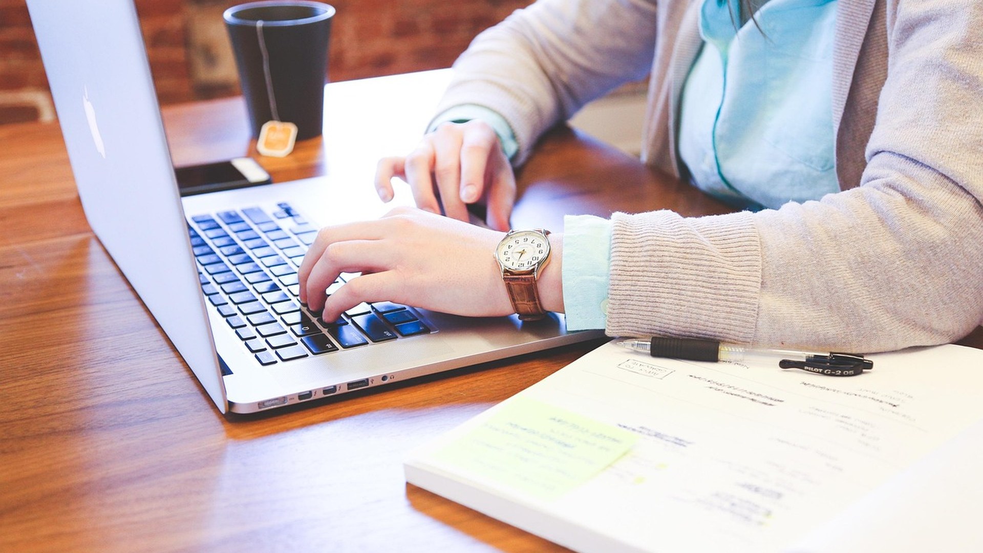 Office worker typing on a laptop for email security and phishing prevention