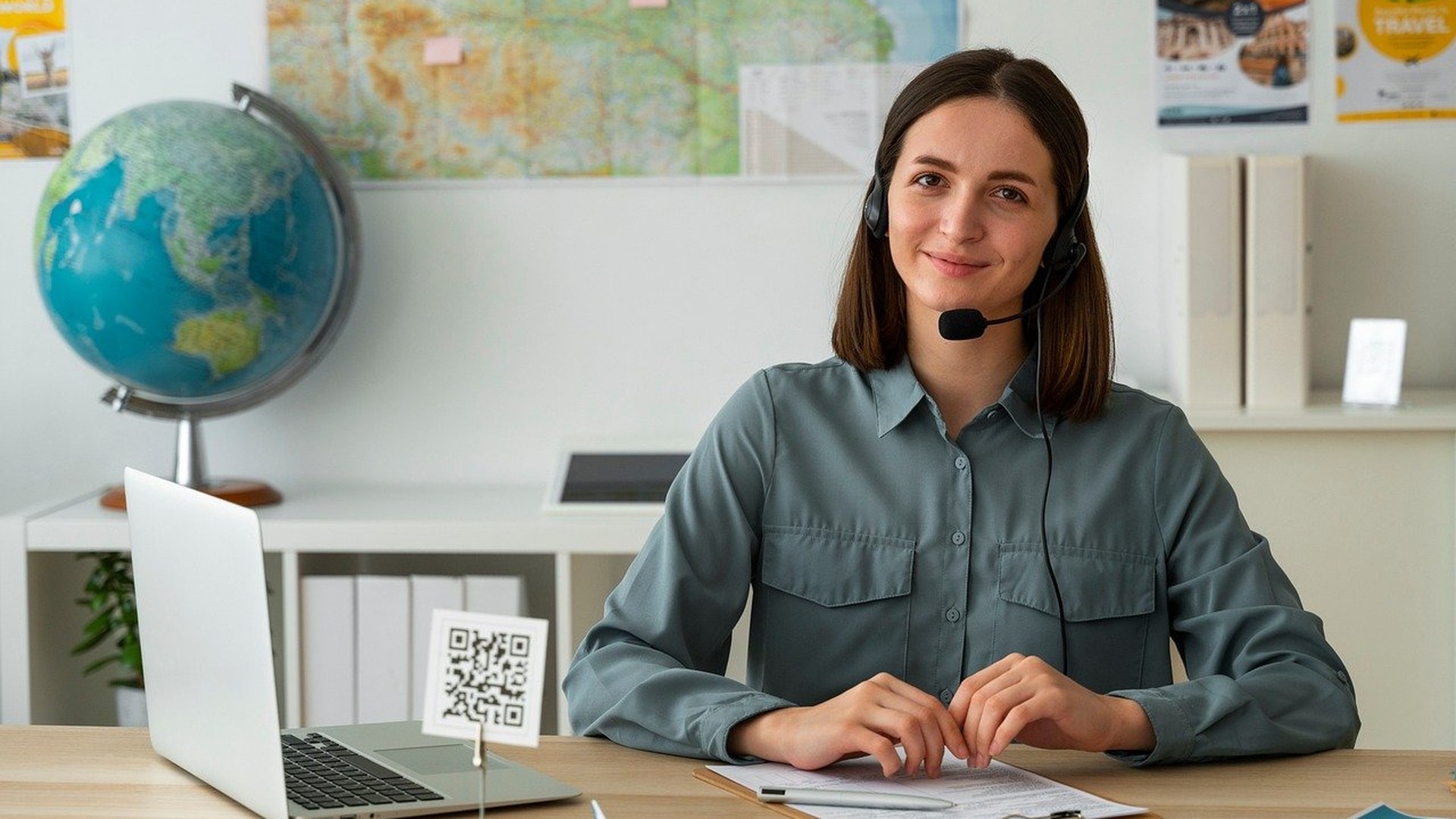 Small business employee on a desk phone headset in an office