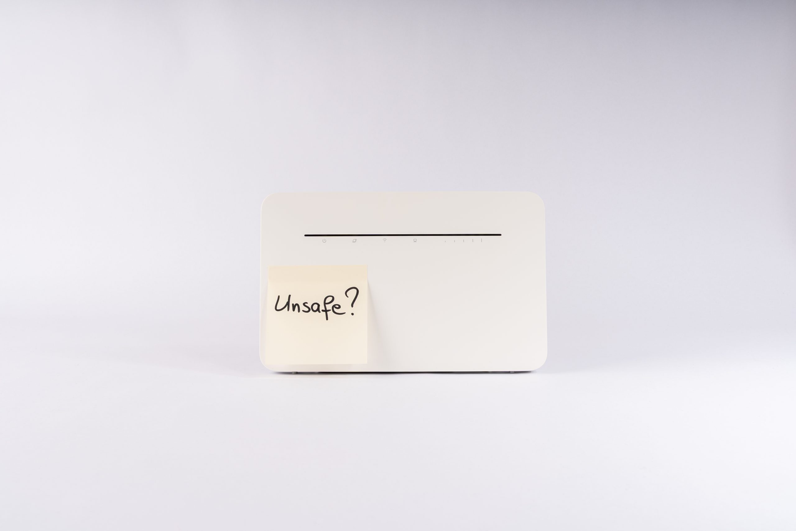 White network device with a sticky note reading Unsafe?