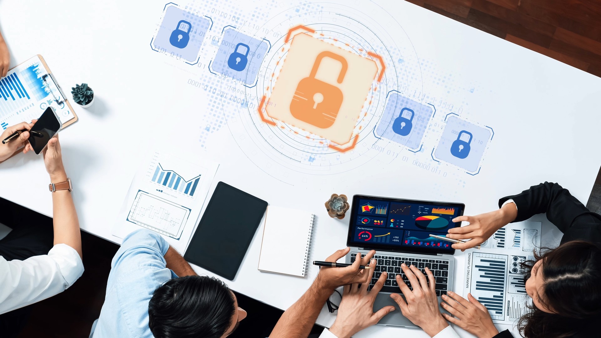 People around a table with laptops and charts beneath blue and orange padlock graphics.
