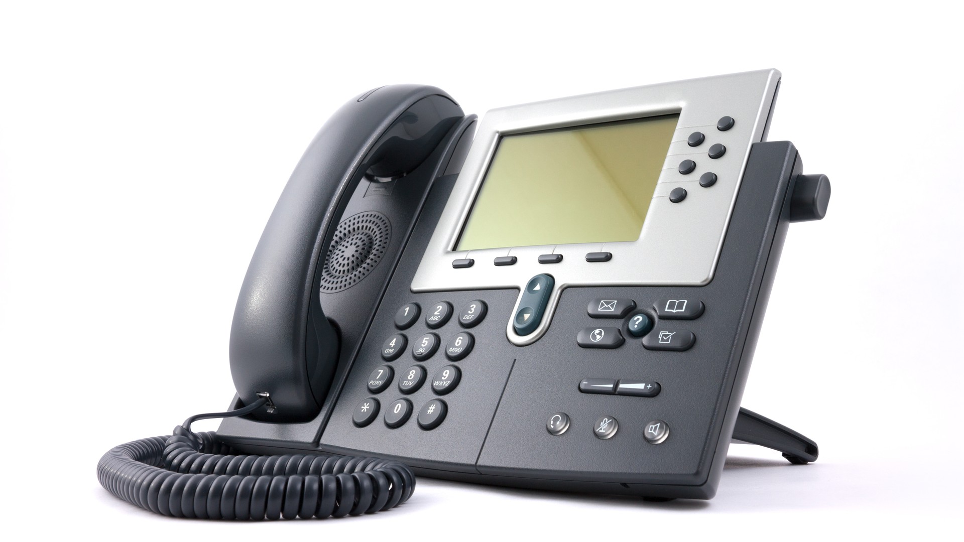 Desk telephone with a display, keypad and coiled handset cord on a white background.