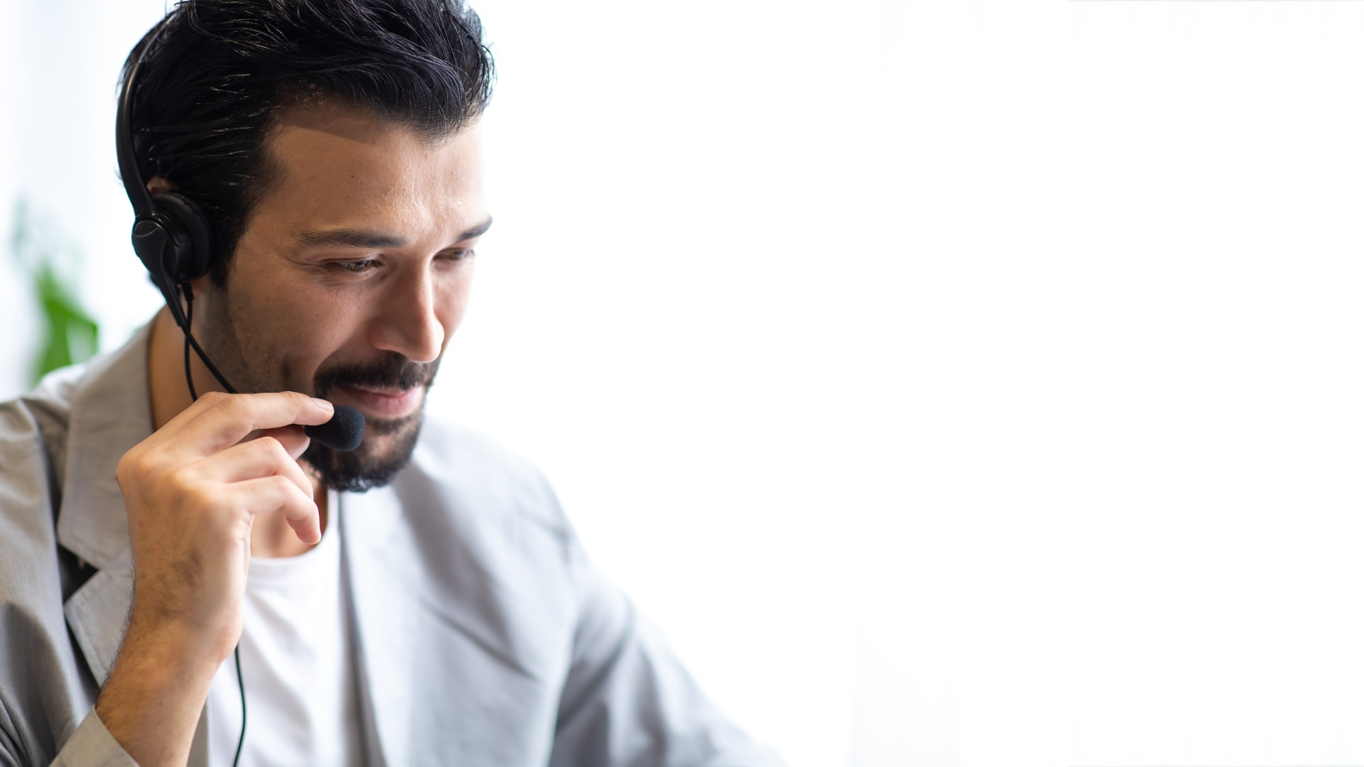 Person wearing a headset and adjusting the microphone near their mouth.